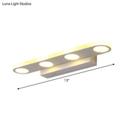 Modern white finish vanity light with acrylic shade and three bulbs designed for maximum bulb wattage in bathrooms