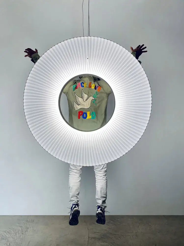 Modern minimalist white led pendant light with circular pleated design and glowing ring for bedroom illumination