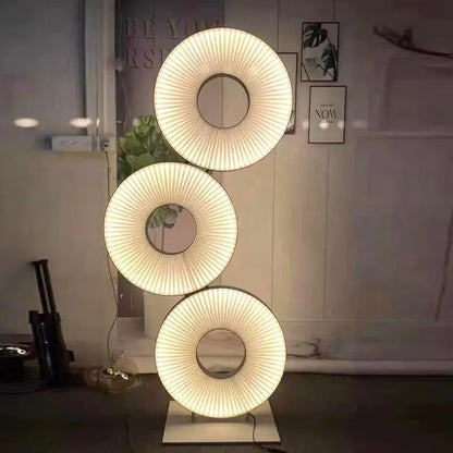 Modern minimalist white led pendant light with three-tiered translucent ribbed shades casting warm glow in bedroom