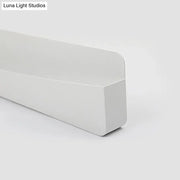 Modern minimalist white wall sconce lamp with a matte-finished rectangular baseboard and clean modern edges for bedroom lighting