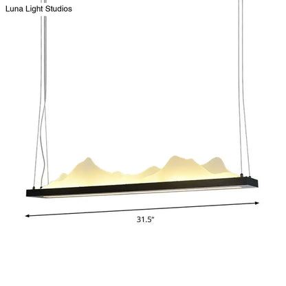 Black acrylic mountain-shaped pendant light with warm yellow led illumination and fixture width of 31.5 to 39 inches