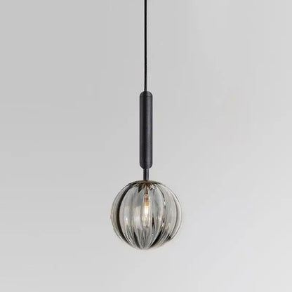 Modern multi color glass pendant light with sleek spherical glass, painted iron finish, and textured black cord for dining room