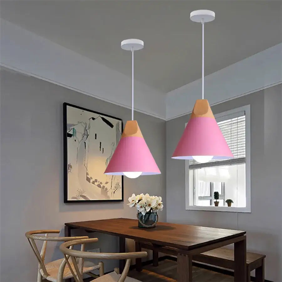 Modern multicolor decorbites cone wood pendant light set with pink and beige conical lights above wooden dining table