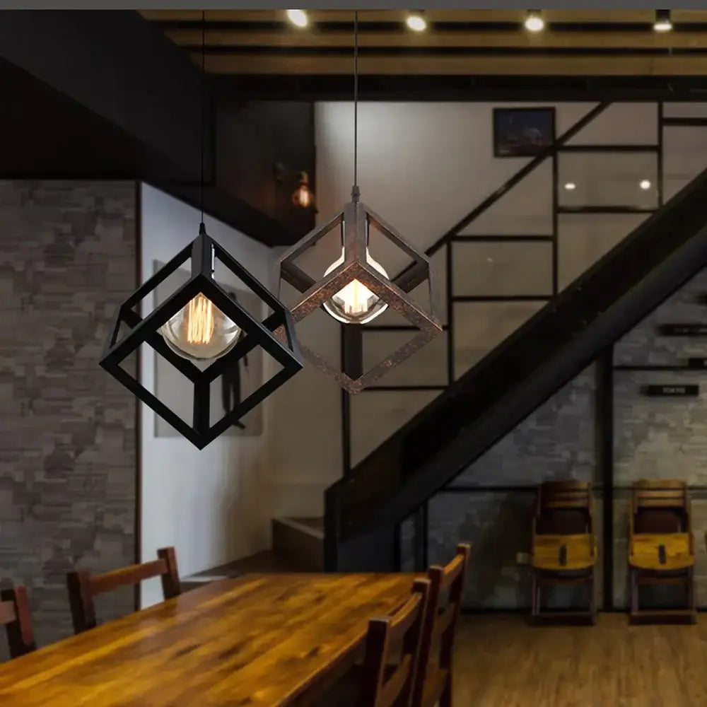Industrial-style black metal geometric cube pendant lights with exposed filament bulbs for modern kitchen decorbites decor