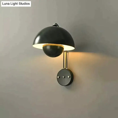 Black matte wall lamp with modern dome shade and brass base type finish for bedroom use
