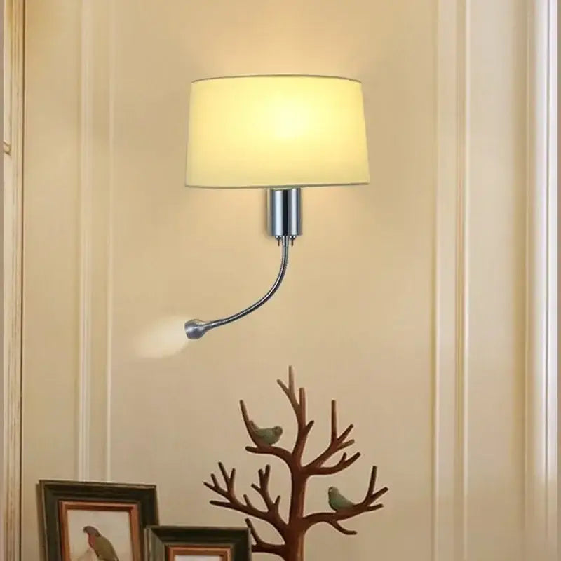 A modern nordic beige elegant fabric wall lamp with sleek chrome finish and adjustable curved arm for bedroom reading light