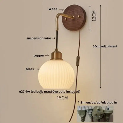 Modern nordic copper adjustable led wall light with a ribbed glass globe, brass finish, and wooden mount for bedroom decorbites wall light