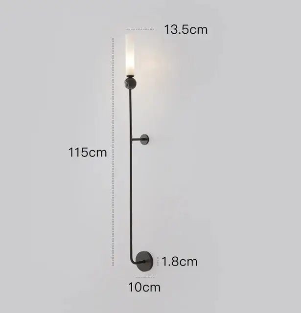 Black metal decorbites copper wall lamp with slender stem, circular base, and frosted glass candle-style bulb for living room