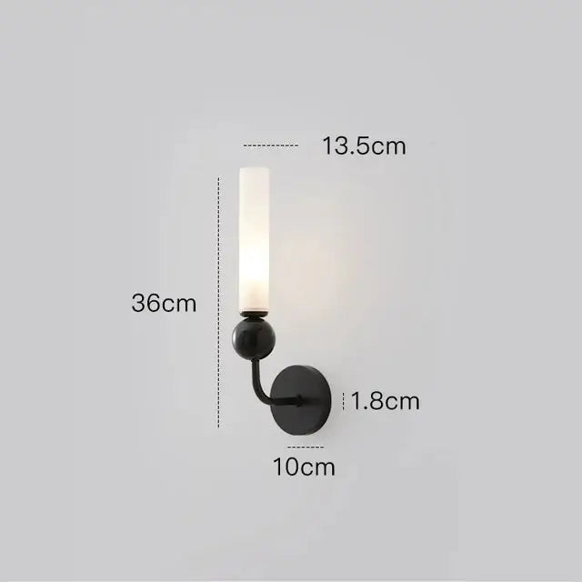 Black metal wall sconce with frosted glass candle-style shade in a modern nordic decorbites copper wall lamp design