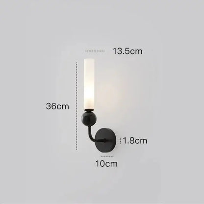Black metal wall sconce with frosted glass candle-style shade in a modern nordic decorbites copper wall lamp design