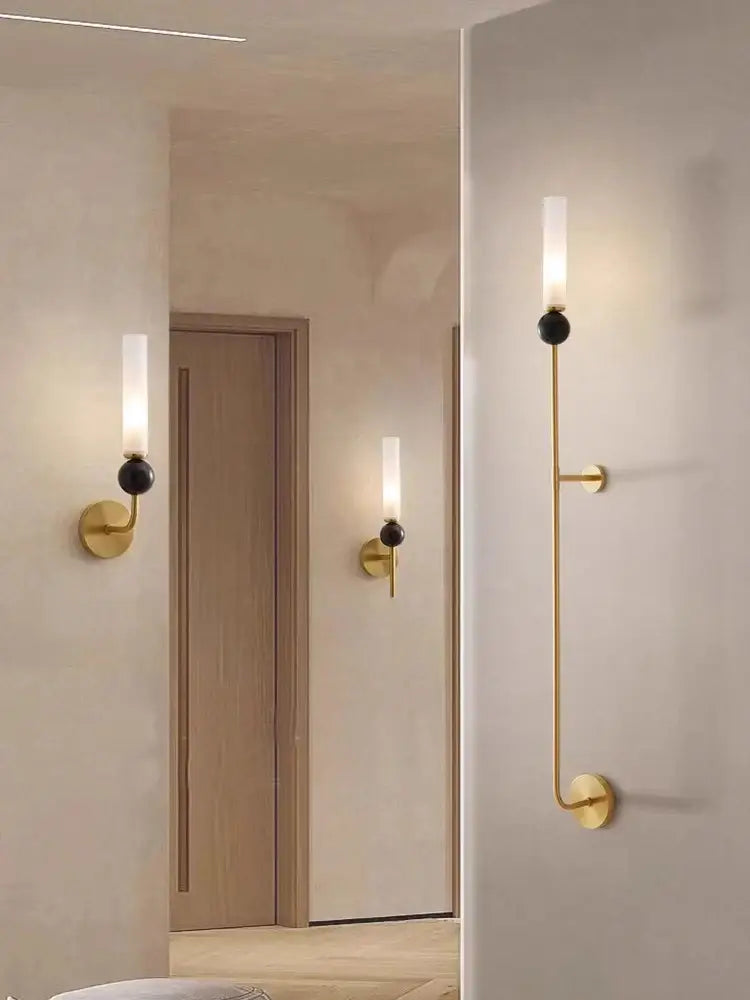 Gold-toned decorbites copper wall lamp with minimalist black sphere and frosted glass cylinder for modern living room decor