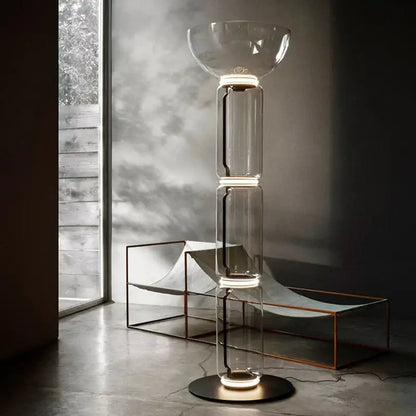 Modern Nordic floor lamp with stacked glass shade LED sections and glowing circular base for living room lighting