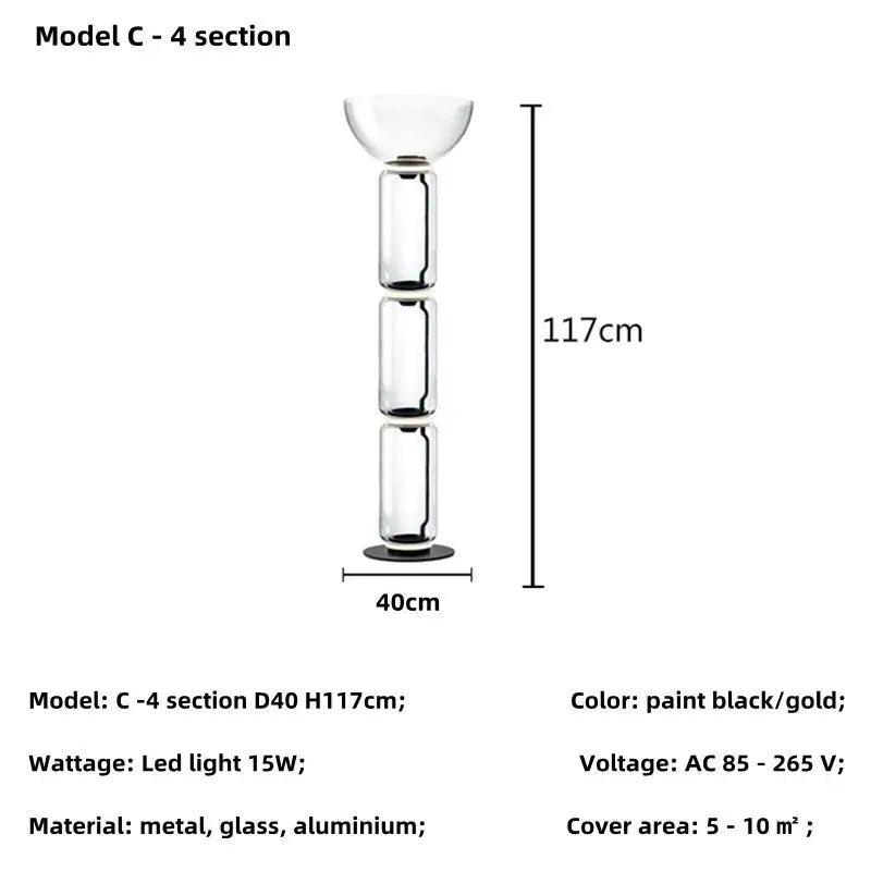 Modern nordic floor lamp with transparent glass shade and black and gold painted metal sections for living room use
