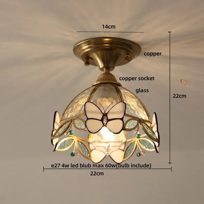 Modern nordic flower led ceiling light with copper finish and stained glass butterfly design accented by green gemstones