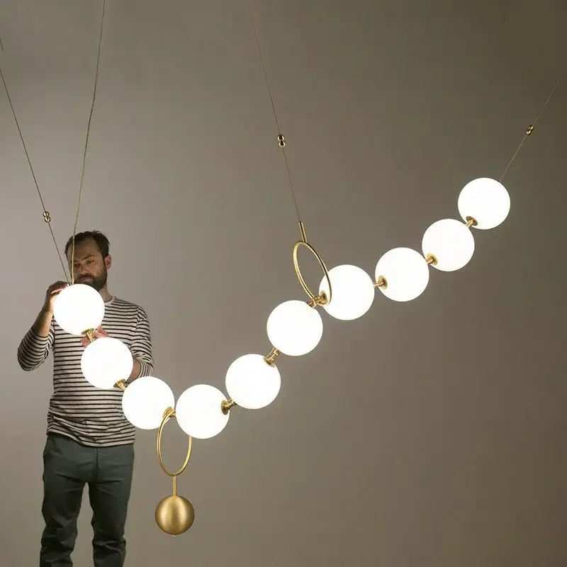 Modern nordic led pendant lamp with frosted white spherical bulbs and gold metal rings for dining room decorbites nordic led