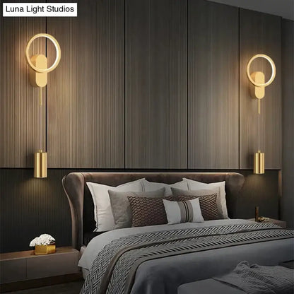Modern nordic led wall lamp featuring gold-toned circular sconces with sleek cylindrical hanging elements in black gold