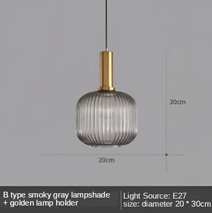 A sleek modern Nordic gray glass led pendant light with ribbed texture and gold-toned holder for dining room