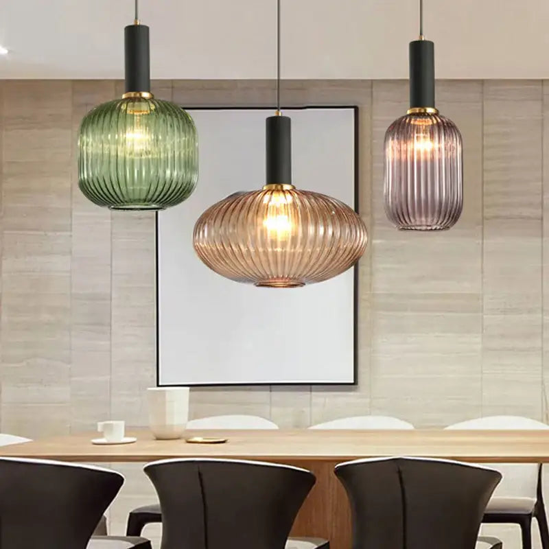 Three modern nordic pendant lights with ribbed green amber and purple glass led shades for dining room lighting