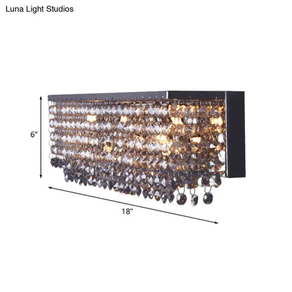Modern octagon crystal wall light with chrome finish features a black rectangular frame and cascading smoky crystal beads