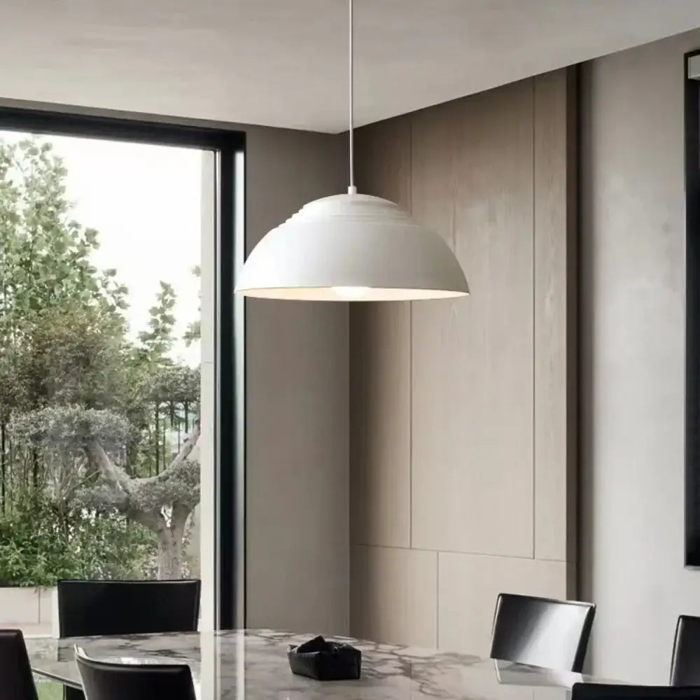 A sleek white glass ball pendant light with a smooth dome shade for modern dining room decorbites glass ball design