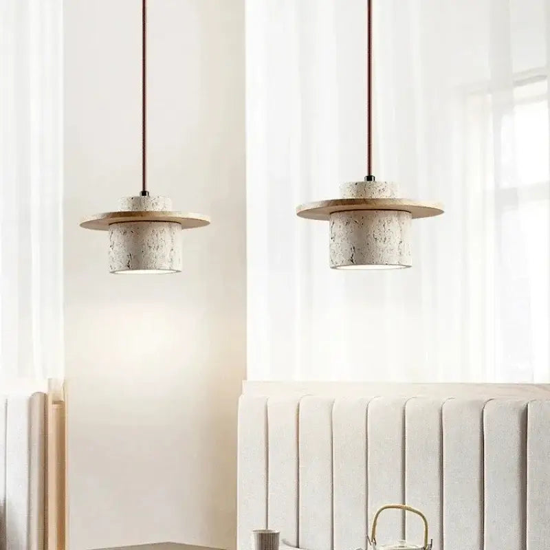 Two minimalist off white stone and wood pendant lights with textured concrete bodies and led bulbs for dining room