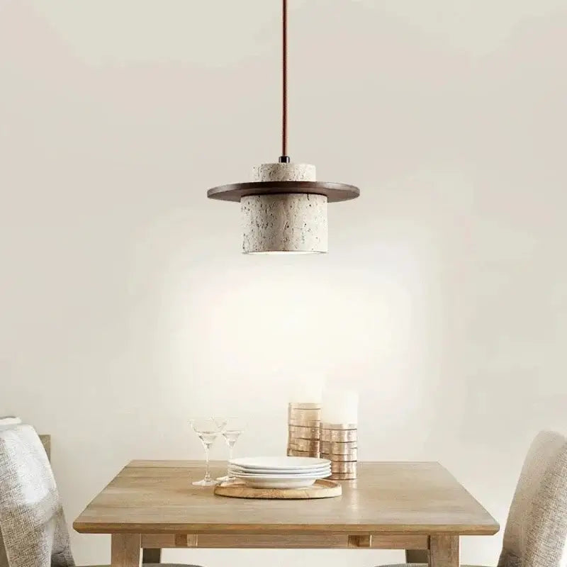 Modern off white stone pendant light with textured concrete body, dark wood ring, and copper cord pendant for softer decorative lighting