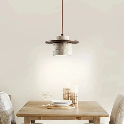 Modern off white stone pendant light with textured concrete body, dark wood ring, and copper cord pendant for softer decorative lighting