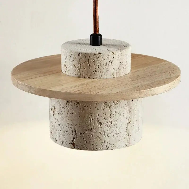 Modern off white stone and wood pendant light with textured concrete base and copper wire cord pendant for softer decorative lighting
