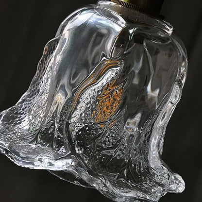 Clear glass bell-shaped pendant lamp with textured bubbly surface and brass top for modern copper glass led decorbites