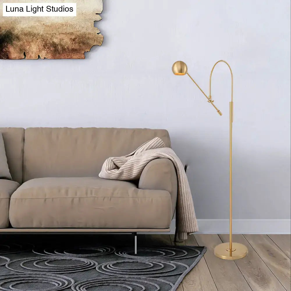 Gold-finished floor lamp with sleek curved arm and spherical head in DecorBites™ modern black metal 110v-120v design