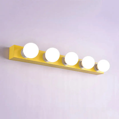 Modern bright yellow rectangular vanity light fixture with five round white bulbs for bedroom use