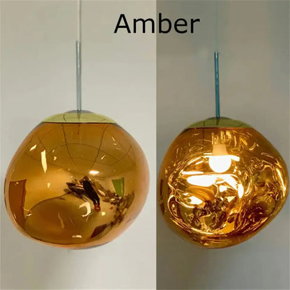 Amber-colored glossy glass pendant light with modern organic form and chrome plated finish for kitchen trio setup