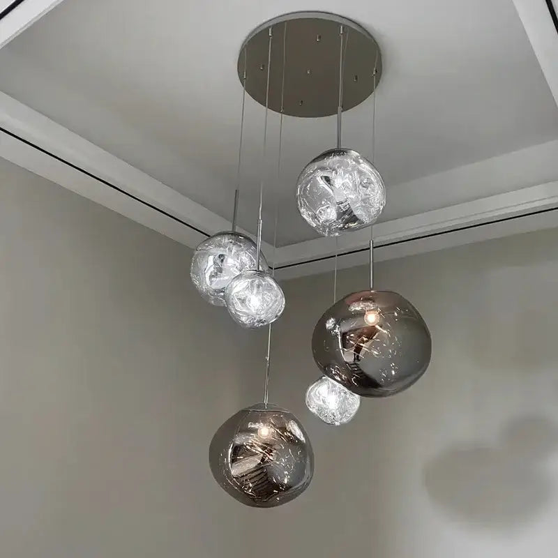 Modern organic form chrome plated finish pendant light trio with spherical chrome finished reflective glass globes