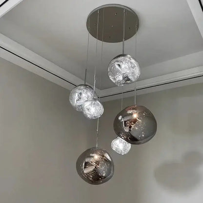 Modern organic form chrome plated finish pendant light trio with spherical chrome finished reflective glass globes