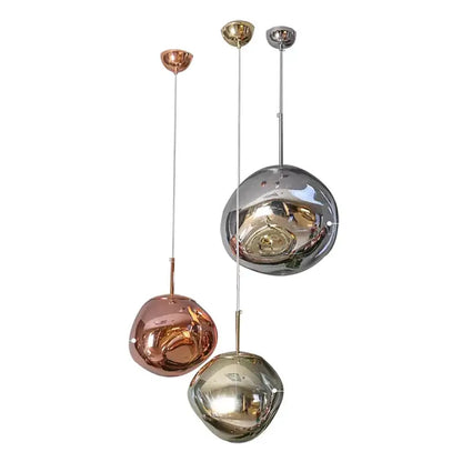 Set of three modern pendant lights with organic form and plated finish in rose gold chrome and silver for kitchen use