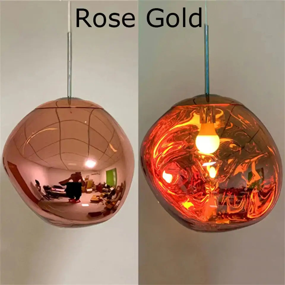 Rose gold spherical pendant light with reflective plated finish and illuminated interior in organic form design