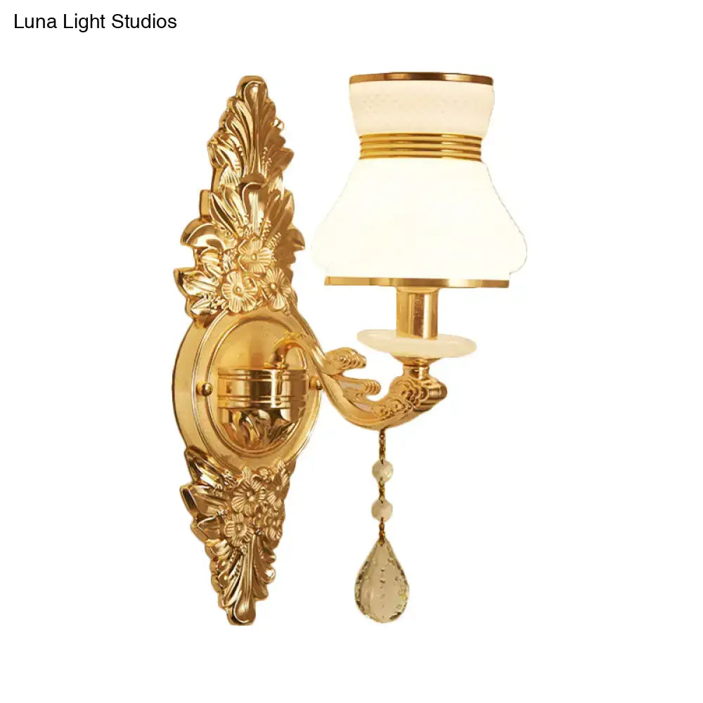Modern ornate gold wall light with frosted glass shade and crystal teardrop pendant for bedroom sconce lighting