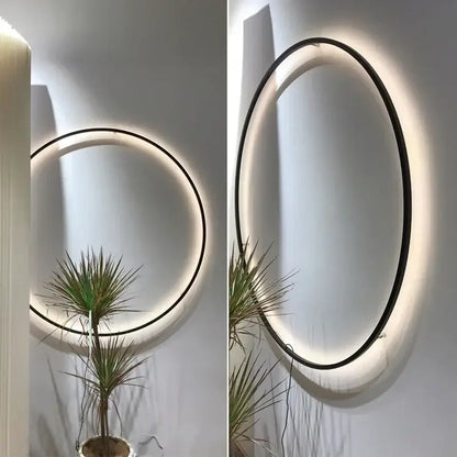 Modern oval led wall sconce with sleek black frame and warm glowing decorbites led ring for bedroom mirror lighting