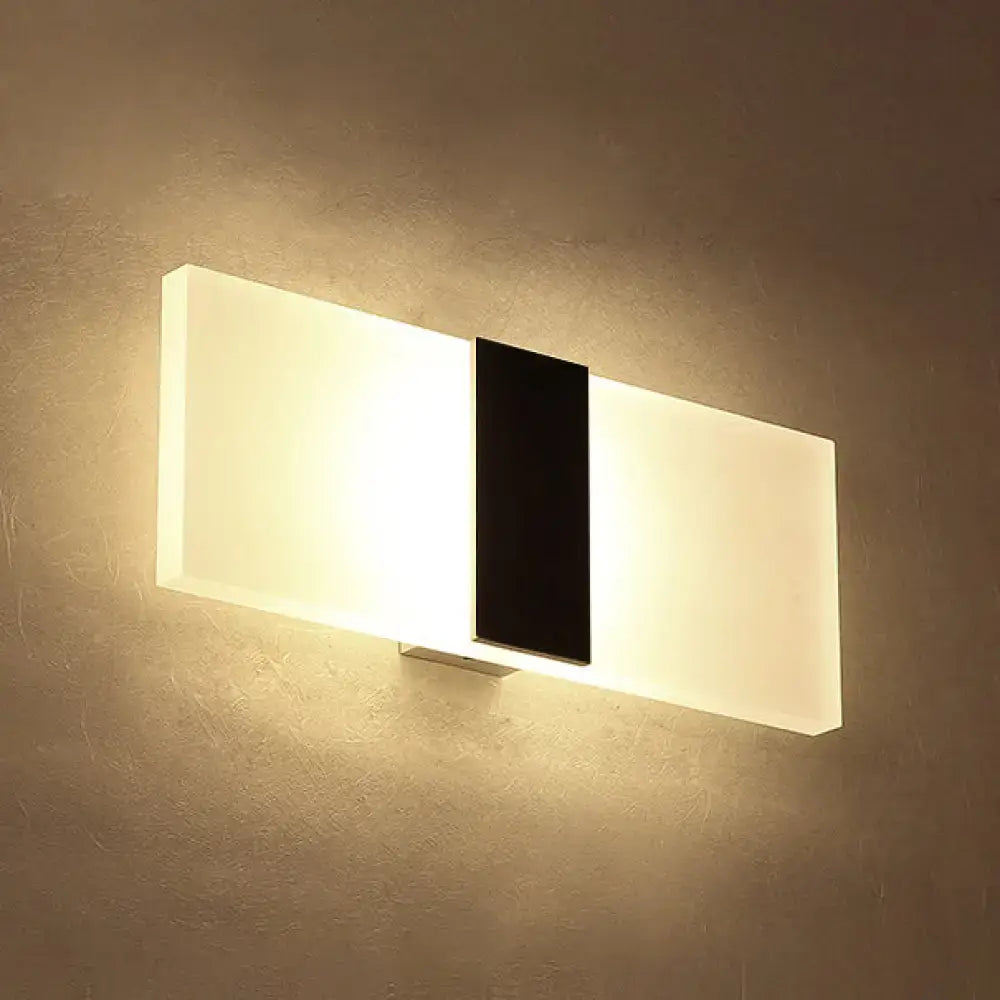 Modern oval rectangular convex led wall sconce with sleek black and frosted white design emitting warm ambient light