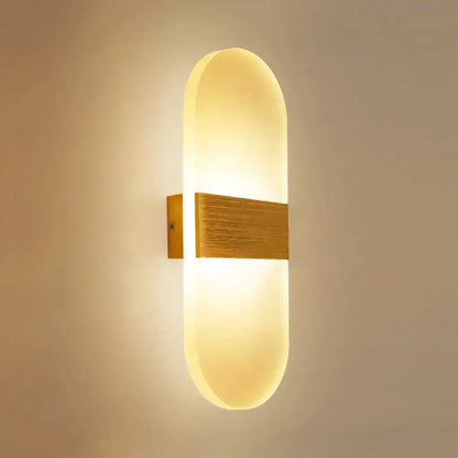 Modern oval rectangular convex led wall sconce with warm-toned frosted glass diffuser and brushed brass accent bar for bedroom lighting