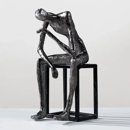 Modern oxidized silver abstract thinkers sculpture by decorbites featuring a contemplative figure on black cube stool