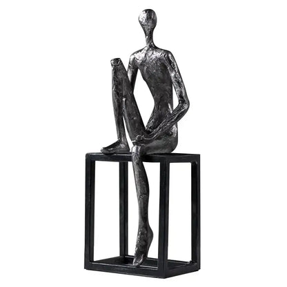 Modern oxidized silver abstract thinkers sculpture with textured dark gray surface on minimalist black cube base decorbites abstract thinkers