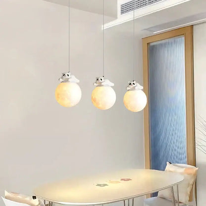 Three white glass pendant bedroom wall lamps with glowing orbs and panda figurines for decorbites bear bedroom decor