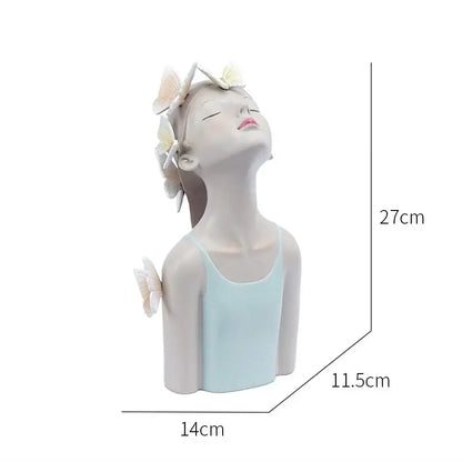 A serene light blue resin butterfly girl sculpture with closed eyes and butterflies in her hair for bedroom decor