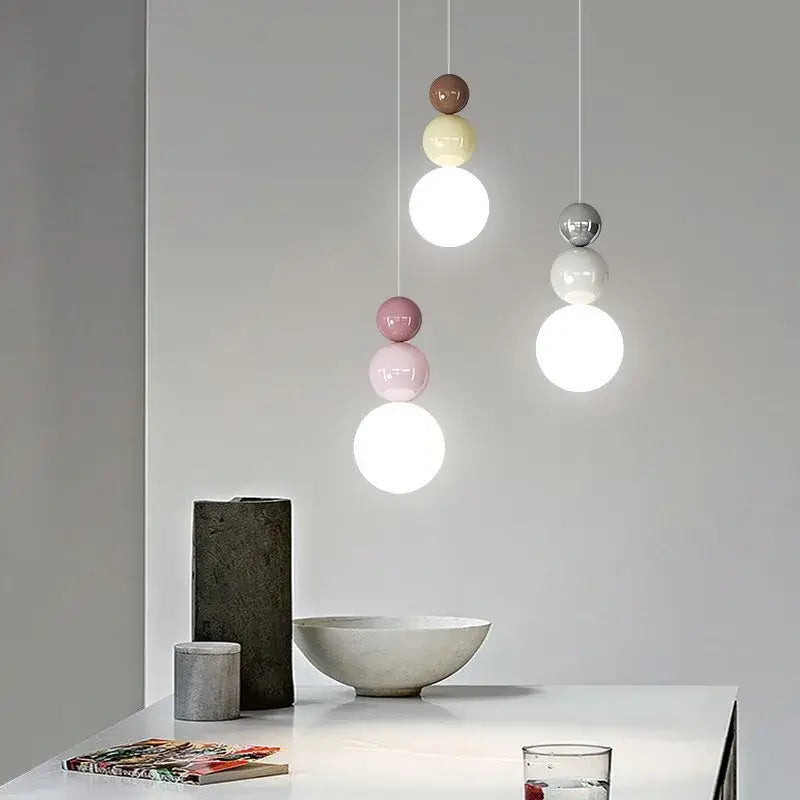 Modern pendant light with stacked spherical glass shades in muted pastels and metallic tones for decorbites cream nordic decor