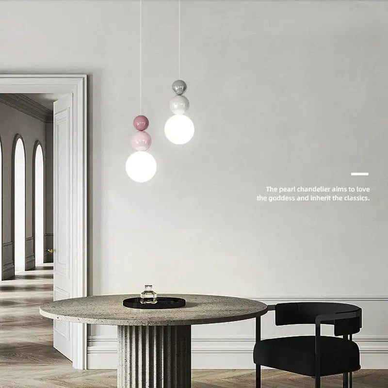 Modern pendant light with spherical white pink and silver glass globes hanging from thin cords for bedroom decorbites cream nordic led lighting