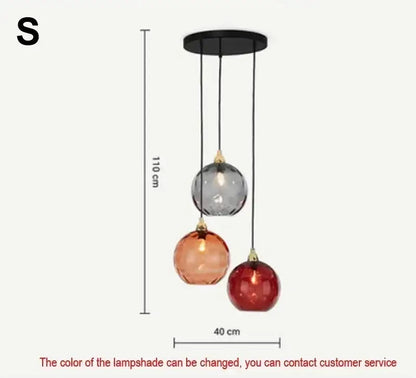 Modern pendant light with seven pastel glass shades in gray amber and red hues in polished chrome for dining rooms