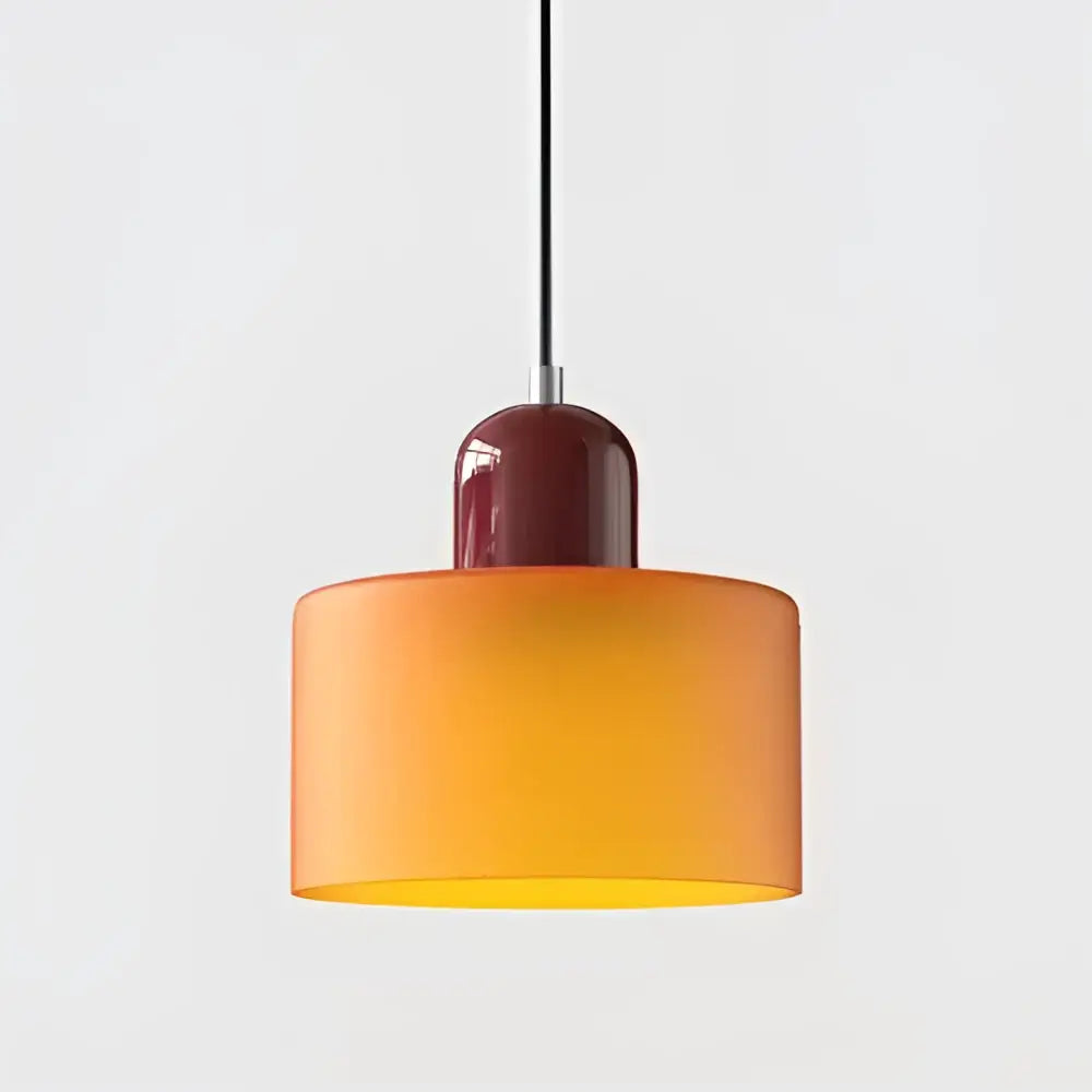 Modern pendant light with gradient orange and yellow stained glass shade and burgundy ceramic fixture for kitchen dining