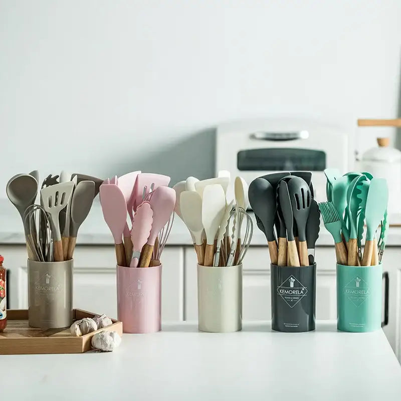 Modern pastel silicone kitchen utensil set with wooden handles in pink beige black and teal with storage box