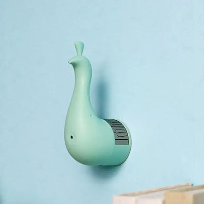 A mint green sleek peacock wall key holder with a circular base for modern bedroom rainbow projection light use